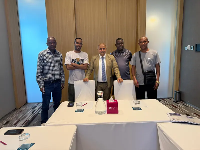 Participants and instructor in a boardroom-style training room
