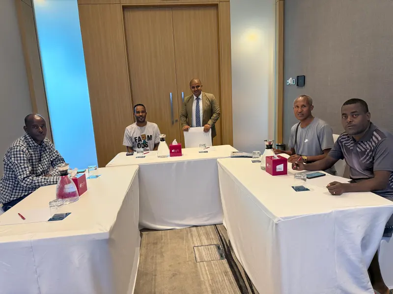 Participants seated around a boardroom table during a training session