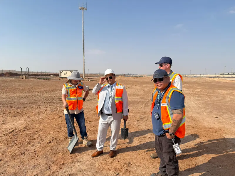 Engineers using measurement equipment on a site